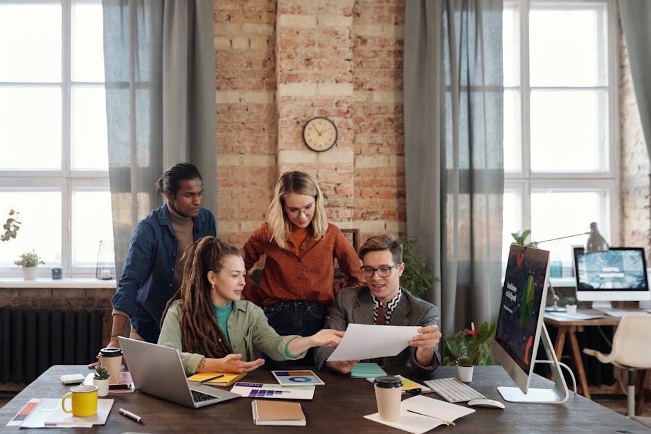 A diverse group of people collaborating on digital marketing strategies, with technology in the background symbolizing innovation.