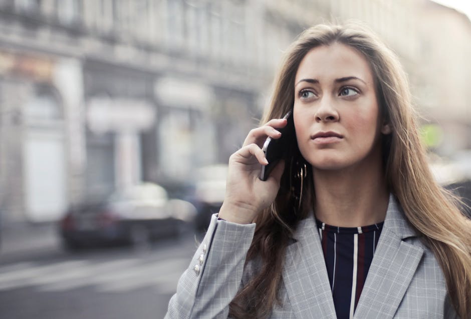 Image of a business professional happily answering a phone call while on the go, symbolizing mobility and connectivity.