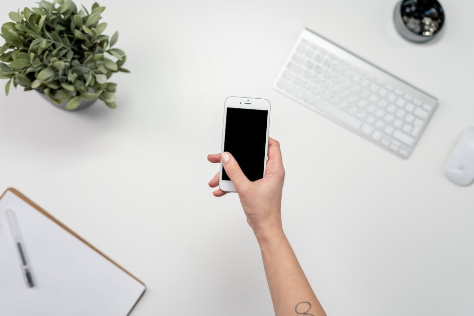 A modern office setup showcasing a business professional seamlessly transitioning phone calls from a desk to a smartphone.