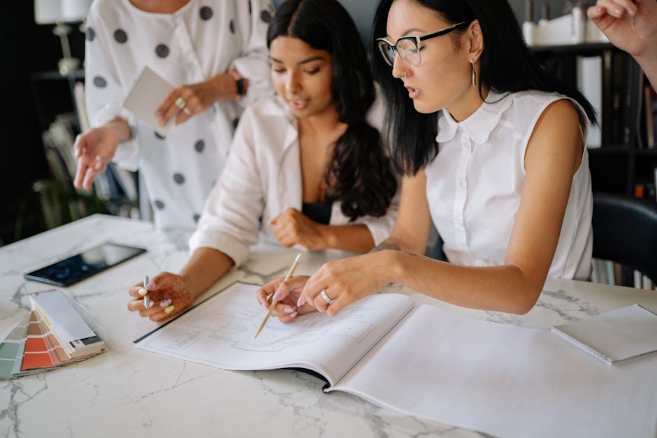 A lively office scene with employees discussing voicemail management solutions around a table, reflecting collaboration and productivity.