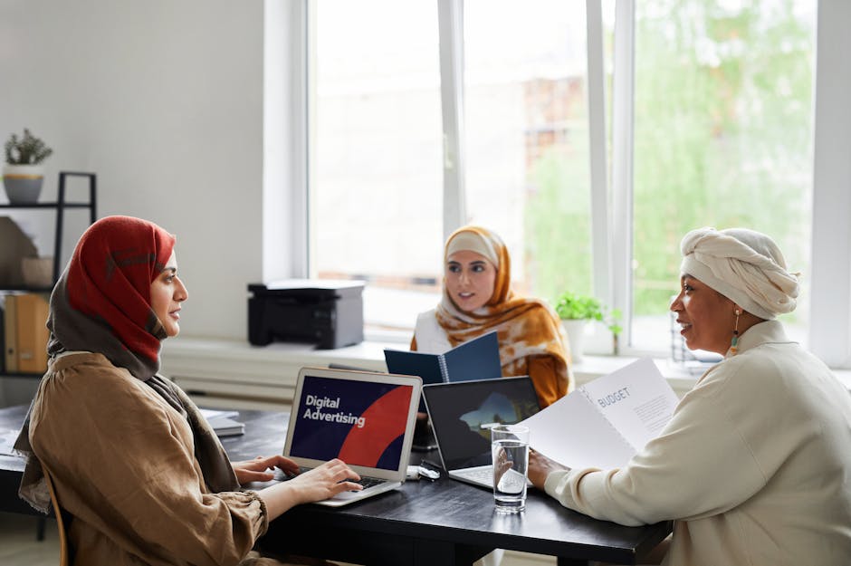 A vibrant office environment where employees are engaged in discussions, utilizing smart devices for efficient communication.