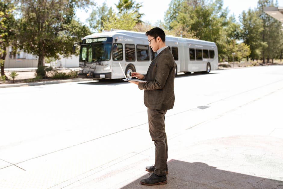 A businessperson using a cell phone in an office environment, demonstrating flexibility in communication.