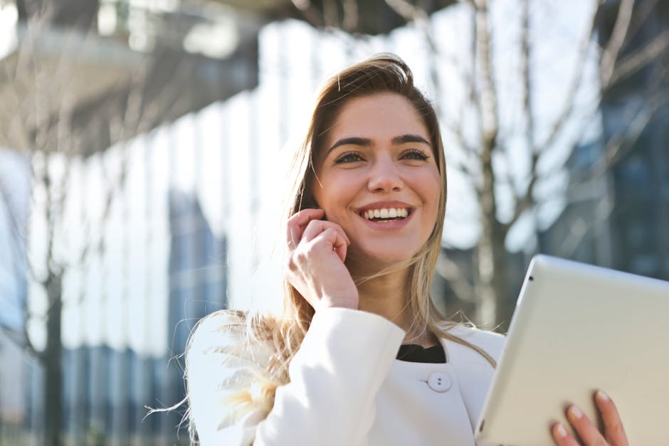 A business person confidently answering the phone with a smile, showcasing professionalism and approachability.