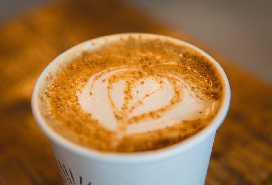 A barista skillfully preparing a specialty coffee drink in a cozy, inviting coffee shop.