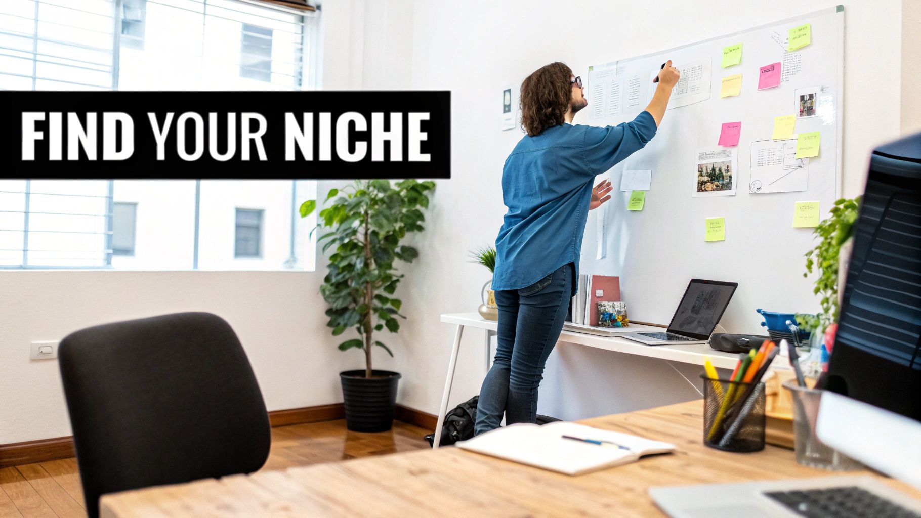 A person at a desk sketching out a business plan with sticky notes on a wall, symbolizing the foundational stage of starting an agency.
