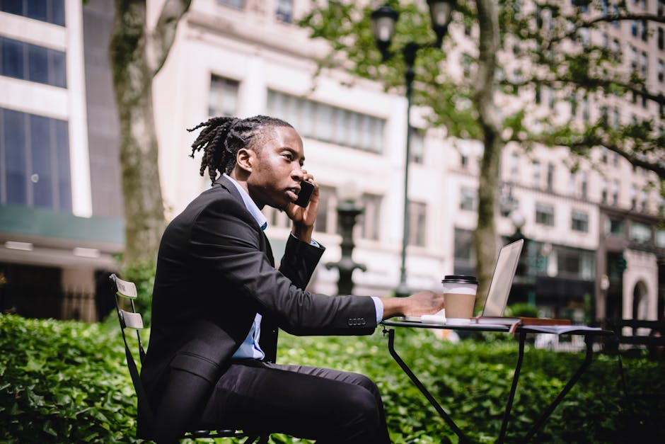 Business professional confidently using a landline phone in a modern office environment.