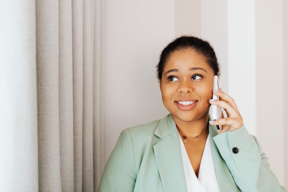 A friendly HVAC technician smiling during a phone call, depicting engagement and professionalism.