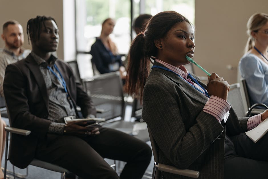 A professional setting where a person is on the phone, looking engaged while taking notes.