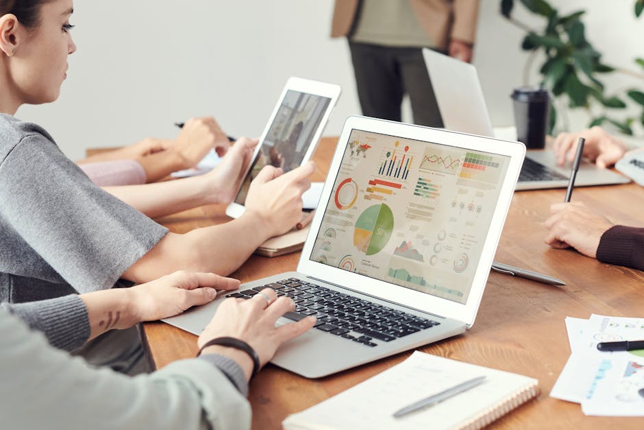 An image showing a busy office environment where a team discusses how to manage customer calls effectively, with visible charts on a screen illustrating optimal dialing times.