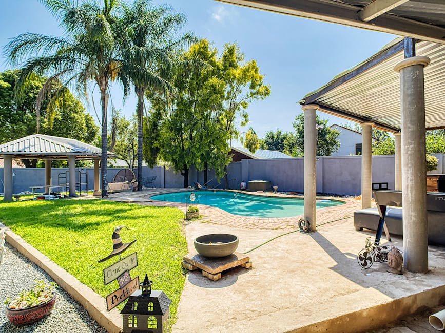 A serene backyard with a well-kept garden, illustrating effective landscaping techniques.