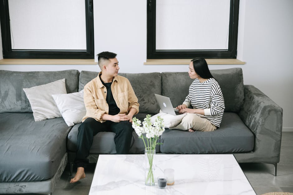 A cozy office setting where a stylist is talking on the phone, surrounded by fashion magazines and style boards.