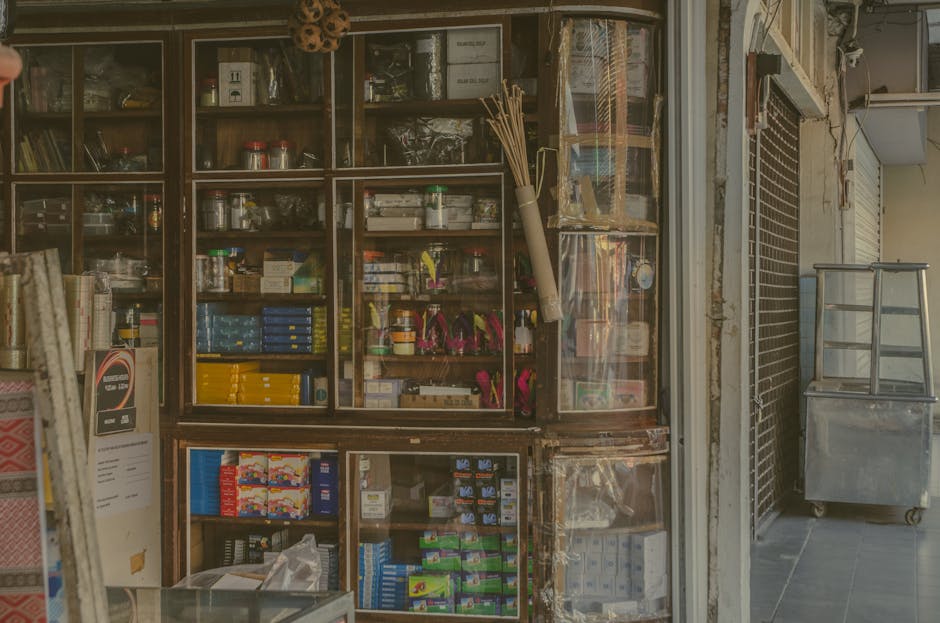 An antique shop displaying a variety of old books and collectibles with staff members communicating with a customer via email.