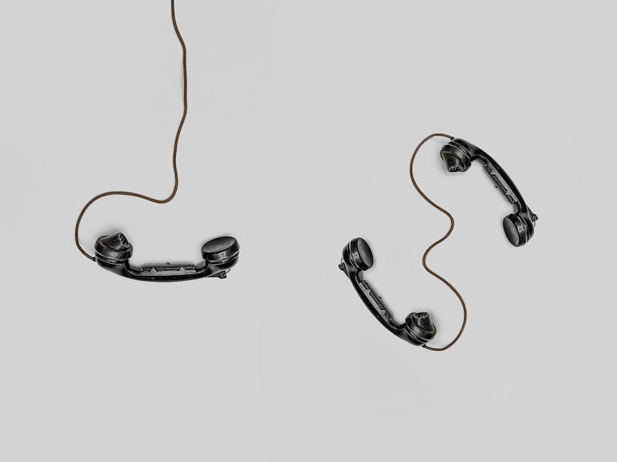 A vintage phone surrounded by antique items, symbolizing the connection between technology and antique business leads.