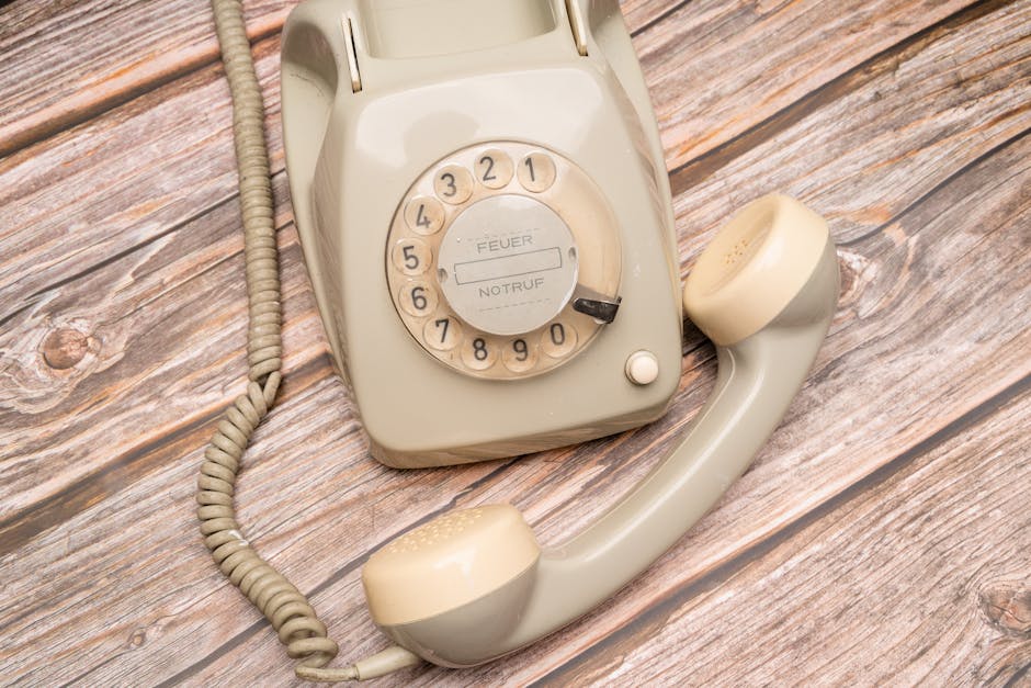 A vintage phone on a wooden desk surrounded by antique items, symbolizing the connection between tradition and modern sales techniques.