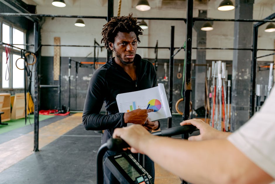 A personal trainer engaging in a phone call with a focus on charting out a client's fitness journey, showcasing determination and connection.