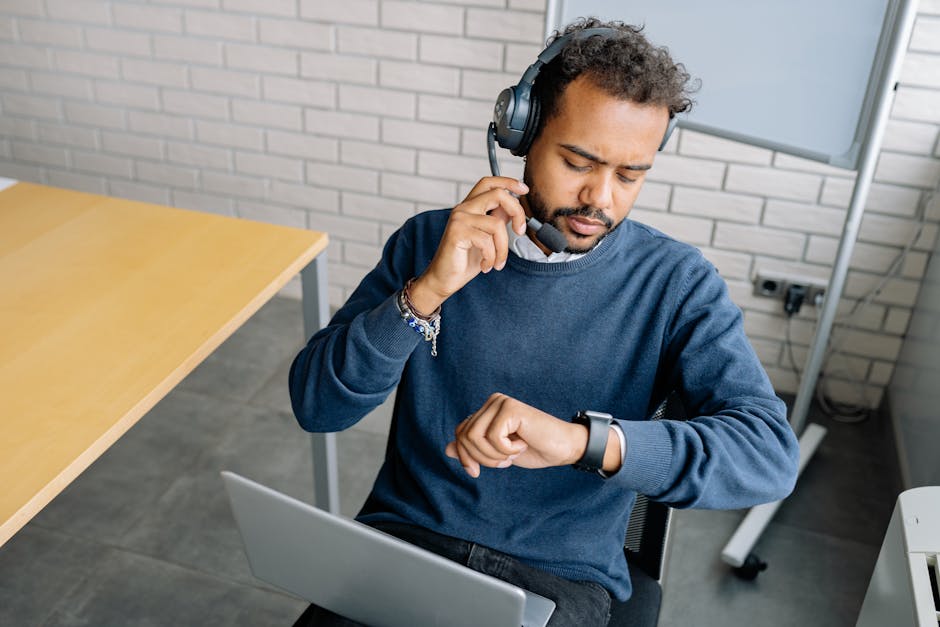 Image of a professional phone agent in a modern office setting, engaging in a role-play scenario with a trainer.