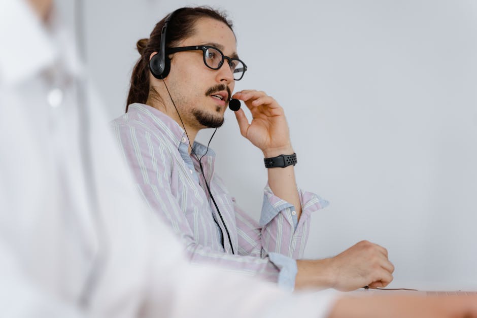 A professional phone agent taking calls in a cozy, tree-themed office with tree trimming tools and client testimonials on the walls.