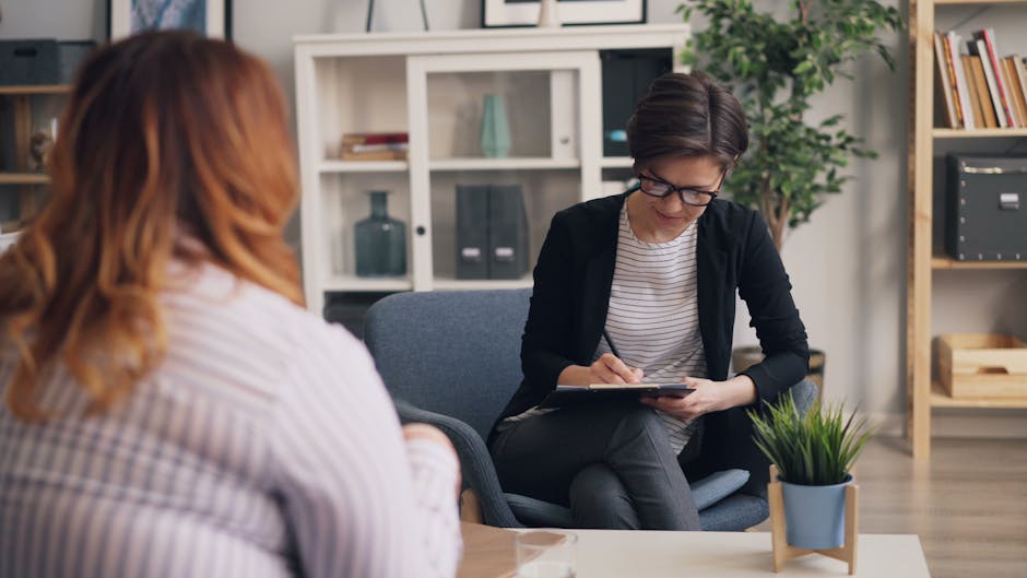 A friendly occupational therapist engaging with a potential client on the phone, showing a supportive and welcoming environment.