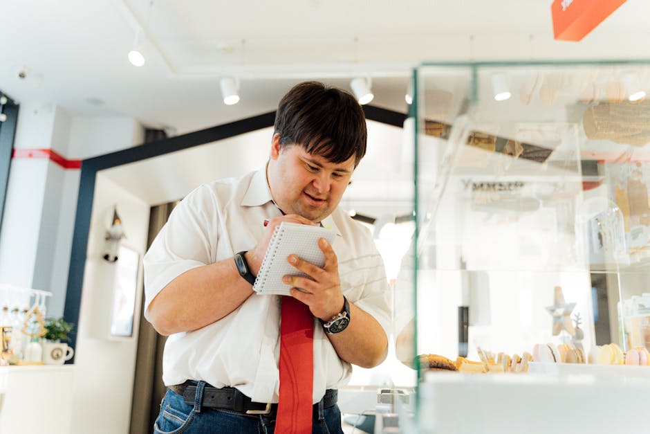 An image of a smartphone repair office with a customer giving feedback to an employee, with both appearing engaged and friendly.