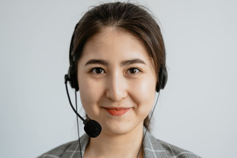 An image showcasing a call agent engaging on the phone with a backdrop of various tea products, highlighting customer interaction.