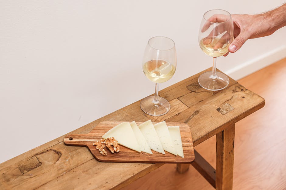 Close-up of a wine tasting setup, highlighting various wine glasses and a rustic table setting.