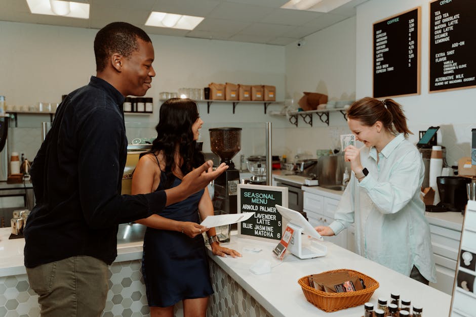 A warm, inviting tea shop interior with a smiling staff member speaking on the phone, showcasing the personal touch in customer engagement.