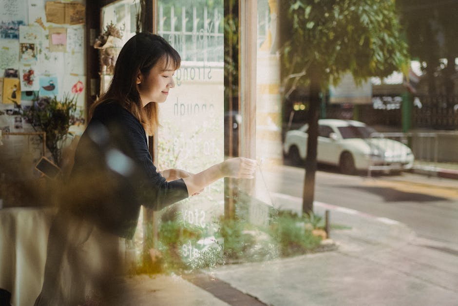 An engaging image of a cheerful bubble tea shop owner on the phone, interacting with a customer, showcasing a welcoming and friendly environment.