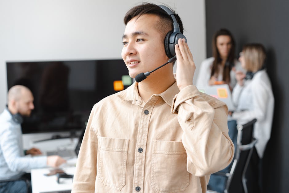 Phone agent in a call center, engaging with a customer using a headset, surrounded by moving company materials and promotional items.