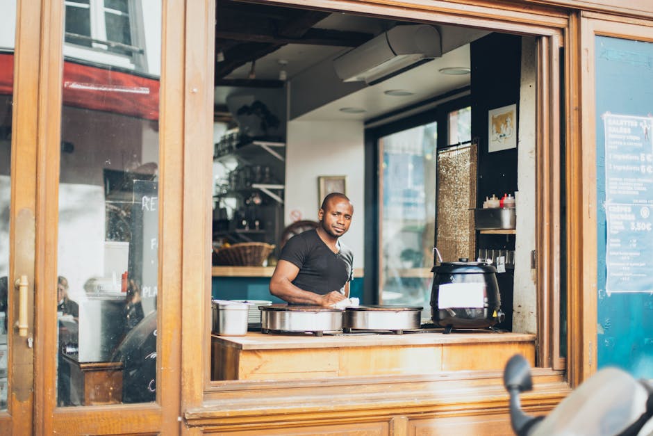 Image of a warm and inviting chocolate shop showcasing beautiful chocolate displays with staff interacting with customers.