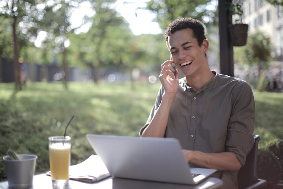 A cheerful phone agent speaking with a potential customer, surrounded by compost bins and greenery.