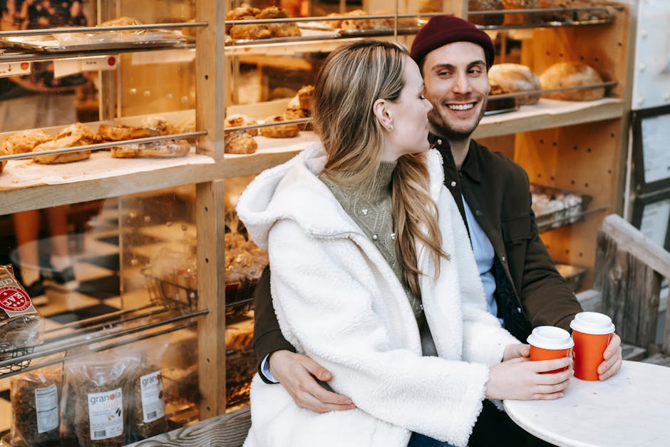 A cheerful bakery worker talking to a customer at a cozy gluten-free bakery shop.