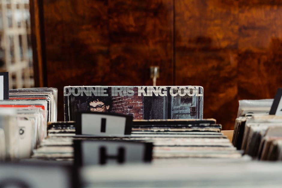 A vintage vinyl record shop with customers browsing shelves and a friendly staff member assisting them.