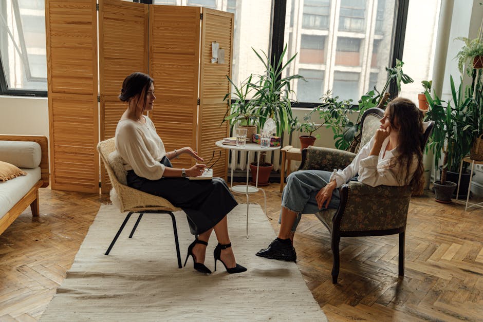 A warm, inviting counseling office with a couple discussing their feelings, highlighting the human aspect of therapy.
