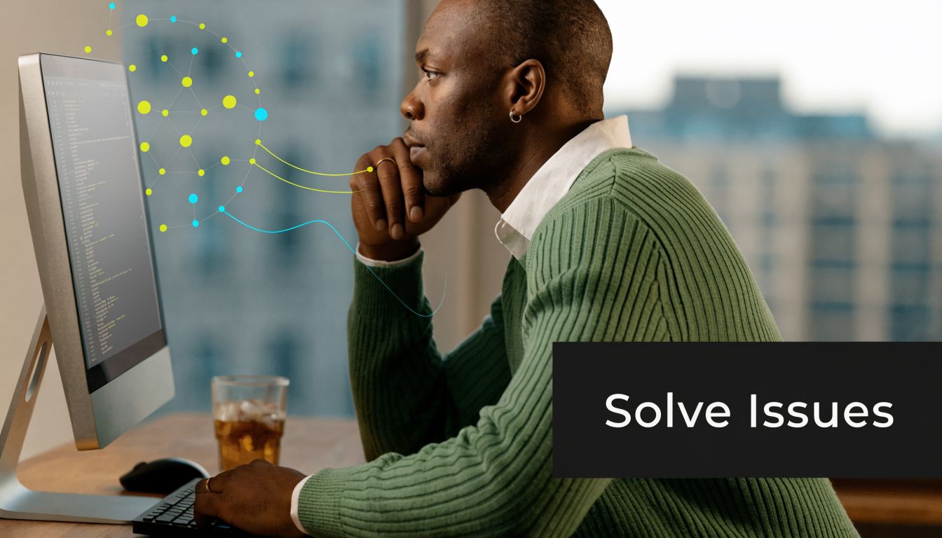 A focused man wearing a green sweater working on computer code while thinking about solving issues.