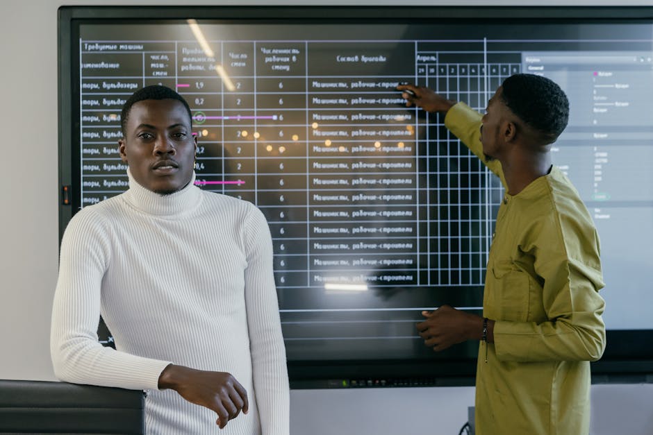 A vibrant office scene with team members engaged in phone conversations and collaborating around digital screens displaying lead management data.
