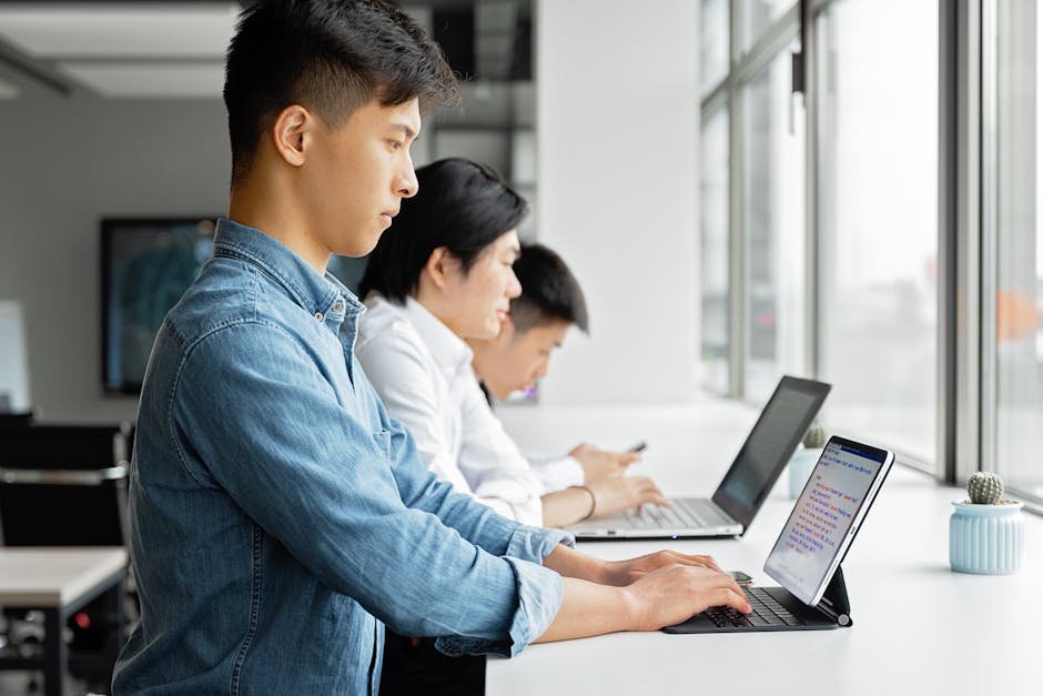 A team in a collaborative workspace making outbound calls using laptops and Google Voice, depicting a high-energy outreach environment.