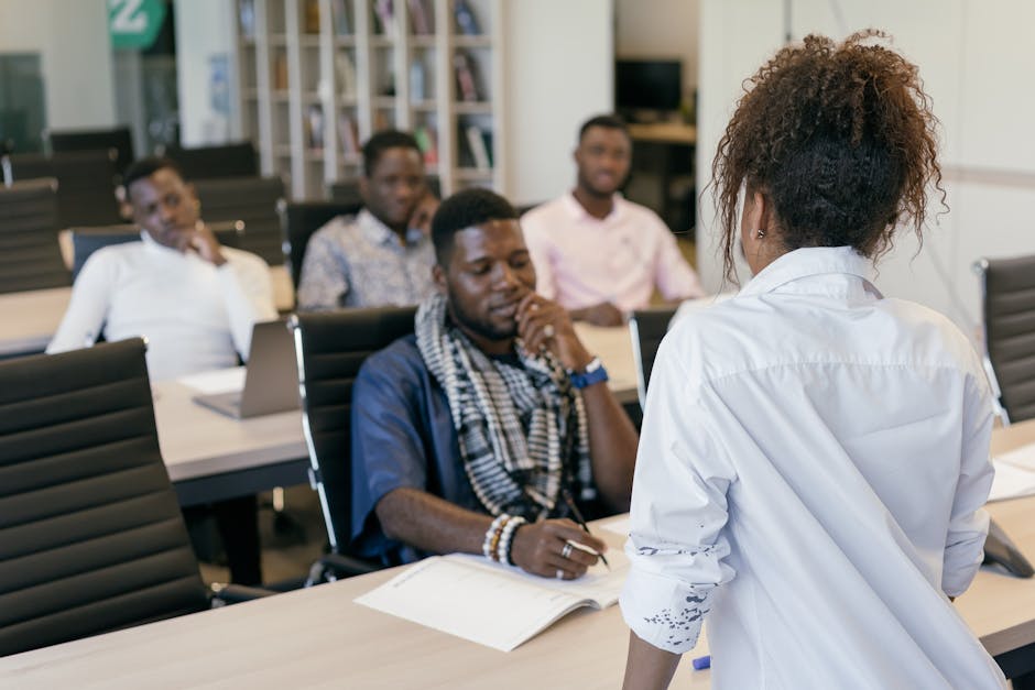 An illustration of a diverse group of professional doula agents in a training session, engaging with potential clients through role play scenarios.