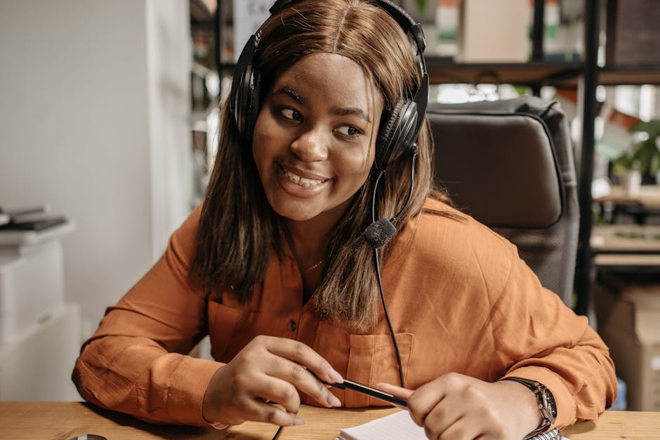 A friendly customer service agent using a modern headset while handling calls in a cozy office environment, showcasing a warm and welcoming atmosphere.