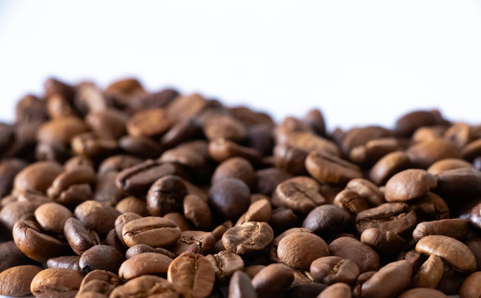A captivating image of a coffee roasting process, showcasing the rich colors and textures of the beans, alongside stories of the farmers involved in sourcing.