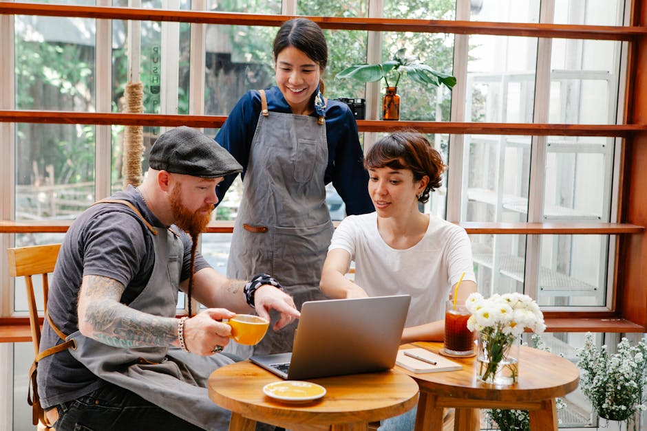A cozy coffee shop with modern technology in use, showcasing a barista interacting with a customer while using a tablet for orders.