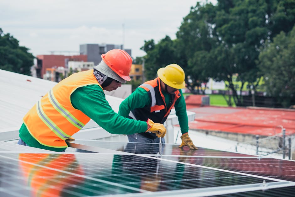 A vibrant green roof installation with workers actively engaged in cleaning up and organizing materials, showcasing efficiency and teamwork.