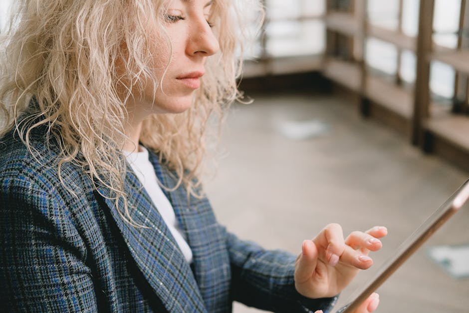 A vibrant office scene showcasing a business owner interacting confidently with a digital AI receptionist interface on a sleek tablet, symbolizing innovation in customer interaction.