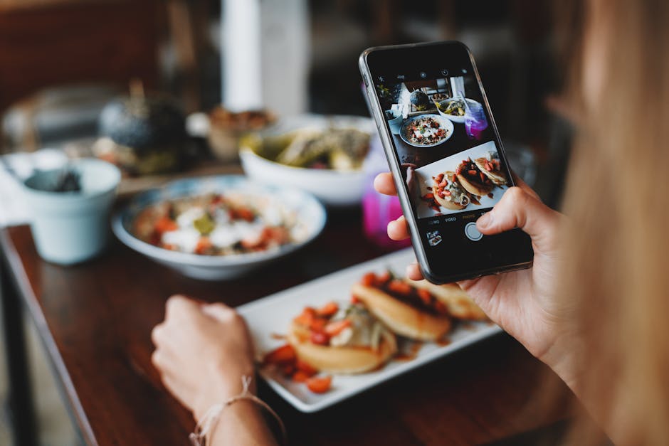 A bright and lively restaurant scene showcasing patrons enjoying their meals, with a visible digital screen displaying reservation confirmations.