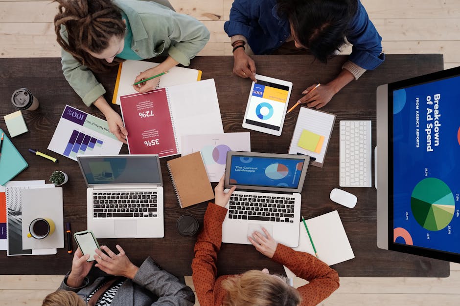A business team evaluating VoIP options, with charts and graphs on a screen.