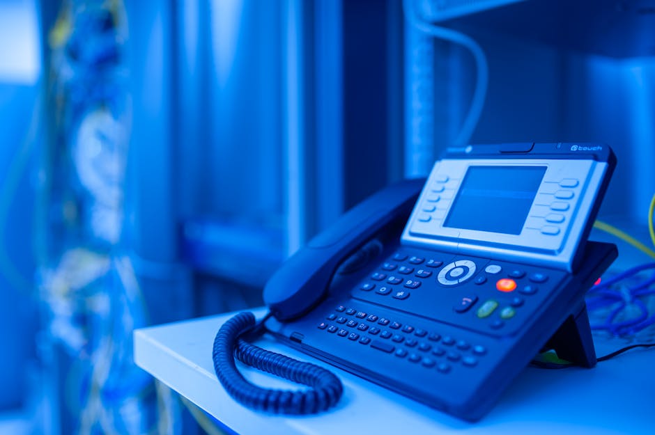 An illustration of a modern office environment showing professionals engaged in a VoIP call with advanced technology, emphasizing connectivity and communication.