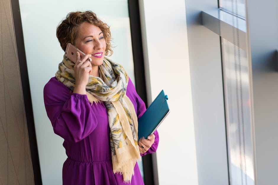 A dynamic image depicting a busy professional texting on a smartphone while interacting with customers in a vibrant office setting.