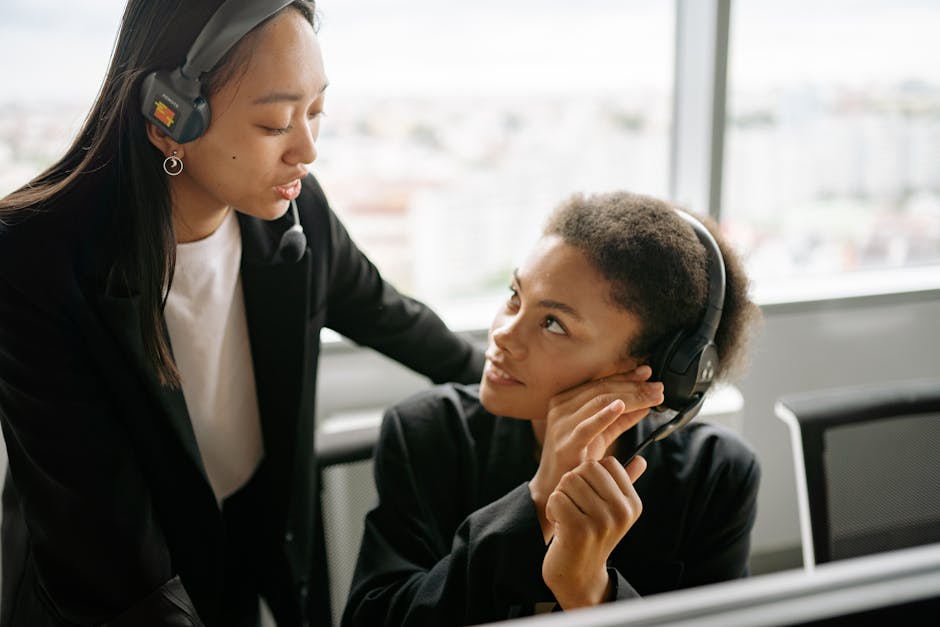 A vibrant workplace scene showing team members reviewing call recordings together, highlighting collaboration and training.