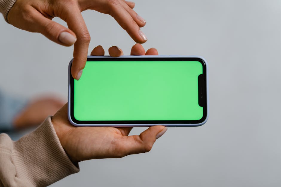 A person eagerly checking their phone for software updates in a modern, sleek environment.