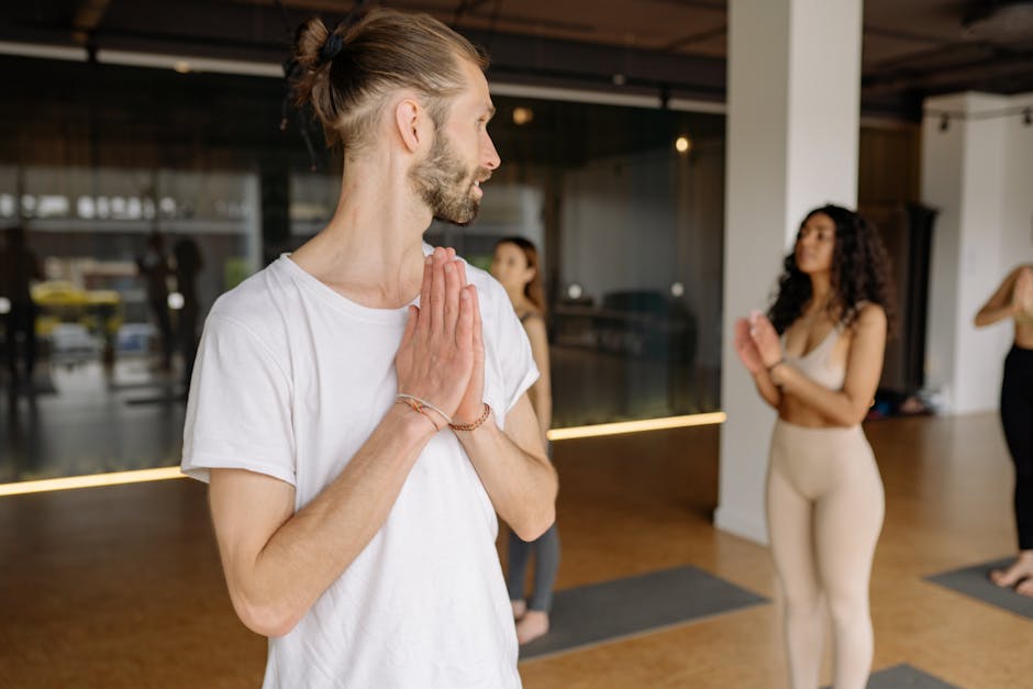 A vibrant yoga class with diverse participants practicing in a sunlit studio filled with plants