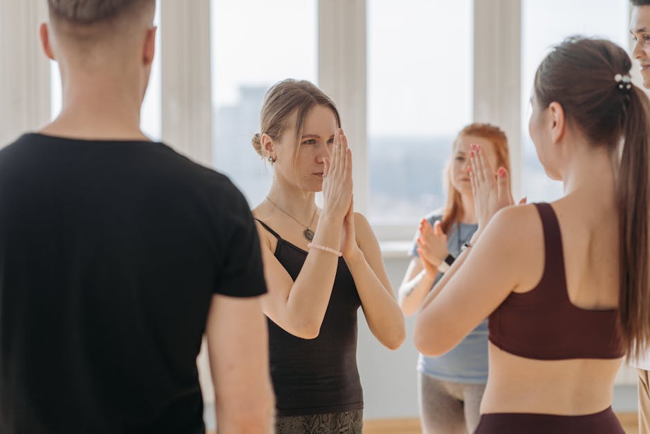 A welcoming yoga studio filled with diverse participants engaged in a class led by an encouraging instructor.